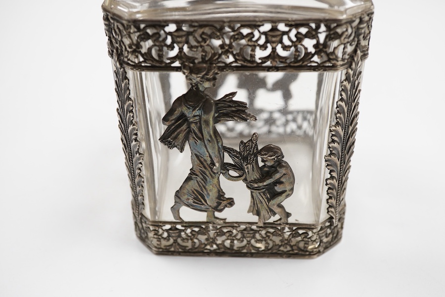 A late 19th/early 20th century French 800 standard pierced white metal mounted glass jar or tea caddy and stopper, decorated with classical scene of a lady with child, height 13.2cm.